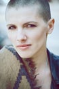 Closeup portrait of sad beautiful Caucasian white young bald girl woman with shaved hair head in leather jacket and scarf Royalty Free Stock Photo