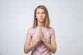 Closeup portrait of a sad young woman praying, hoping, begging for the best isolated on white background Royalty Free Stock Photo