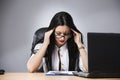 Closeup portrait, sad young woman in white gray suit sitting on Royalty Free Stock Photo