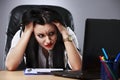 Closeup portrait, sad young woman in white gray suit sitting on Royalty Free Stock Photo