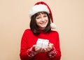 Closeup portrait of Santa girl holding christmas gift. Young hap Royalty Free Stock Photo