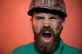 Closeup portrait screaming construction worker in hard hat. Angry builder in safety helmet. Shouting bearded man in Royalty Free Stock Photo