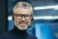 Closeup portrait of senior mature boss with headset, video call, man smiling and looking at camera, gray haired Royalty Free Stock Photo
