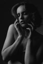 Closeup portrait of sensual brunette model with curly hair and bare shoulders. Black and white toning Royalty Free Stock Photo