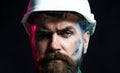 Closeup portrait of serious bearded architect, engineer or designer in protective hard hat. Industrial or mechanical Royalty Free Stock Photo