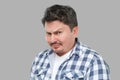 Closeup portrait of serious handsome middle aged business man in casual checkered shirt standing and looking at camera with Royalty Free Stock Photo