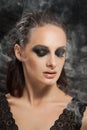 Closeup portrait of a serious lady with smoky eye makeup Royalty Free Stock Photo