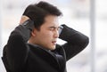 Closeup portrait shot of Asian young black short hair stress depress unhappy male businessman worker in formal suit hold hands up Royalty Free Stock Photo