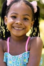 Closeup portrait of smiling african american cute girl with dreadlocks looking at camera Royalty Free Stock Photo