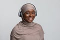 Closeup Portrait Of Smiling Black Muslim Woman In Hijab Using Wireless Headphones Royalty Free Stock Photo