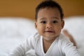 Closeup Portrait Of Smiling Cute Little Black Baby Relaxing On Bed Royalty Free Stock Photo