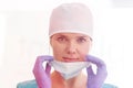 Closeup portrait of smiling doctor wearing surgical cap removing mask at clinic Royalty Free Stock Photo