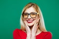 Closeup Portrait of Smiling Girl in Eyeglasses and Red Top on Green Background. Young Blonde with Long Hair and Charming Royalty Free Stock Photo