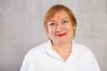 Closeup portrait of smiling older woman in white shirt Royalty Free Stock Photo