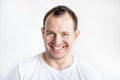 Closeup portrait of smiling 30 years old caucasian white man on white background in white t-shirt. Confident happy smart modern Royalty Free Stock Photo