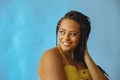 closeup portrait of smiling young beautiful african american woman braid hair posing at studio looking away at copy Royalty Free Stock Photo