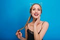 Closeup portrait of smiling young pretty women enjoying herself at party, masquerade, carnival, posing at blue