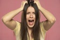 Closeup portrait stressed frustrated woman screaming isolated on pink background Royalty Free Stock Photo