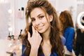 Closeup portrait stylish cute young woman with long brunette hair smiling to camera in hairdresser salon. Beauty Royalty Free Stock Photo