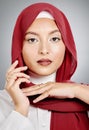 Closeup portrait of a stylish muslim woman posing in a studio with a hijab. Headshot of a stunning confident arab model