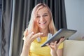 Closeup portrait of talking teenage girl with digital tablet looking at video camera