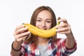 Teen girl outstretching giving you a banana Royalty Free Stock Photo