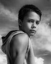 Closeup portrait of teenager boy looking at camera in black and white, candid childhood Royalty Free Stock Photo