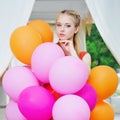 Closeup portrait of tender young woman with balloons