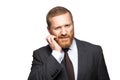 Closeup portrait of thoughtful confused handsome businessman with beard in black suit standing scratching his face and looking at