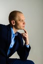 Closeup portrait of thoughtful man in suit onlight grey background Royalty Free Stock Photo