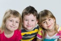 Closeup portrait of three cheerful children