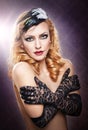 Closeup portrait of a topless blonde woman wearing black lace gloves