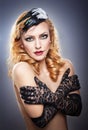 Closeup portrait of a topless blonde woman wearing black lace gloves