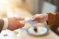 Closeup portrait of two successful business executive exchanging business card