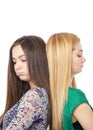 Closeup portrait of two sulky teenage girls standing back to back Royalty Free Stock Photo