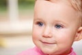 Closeup portrait of white Caucasian wet baby girl in water swimming pool inside