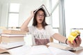 Closeup portrait of white woman surrounded by tons of books, alarm clock, stressed from project deadline, study, exams