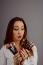 Closeup portrait of a woman applying dry cosmetic on the face using makeup brush Royalty Free Stock Photo