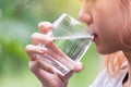 Closeup portrait woman drinking water bottle in nature refresh for her live