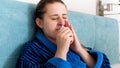 Closeup portrait of young woman feeling unwell using nasal spray Royalty Free Stock Photo