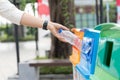 Closeup portrait woman hand throwing empty plastic water bottle in recycling bin Royalty Free Stock Photo