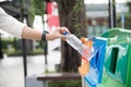 Closeup portrait woman hand throwing empty plastic water bottle in recycling bin Royalty Free Stock Photo