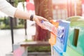 Closeup portrait woman hand throwing empty plastic water bottle in recycling bin Royalty Free Stock Photo