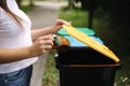 Closeup portrait woman hand throwing empty plastic water bottle in recycling bin Royalty Free Stock Photo