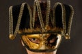 Closeup portrait of woman isolated over dark background wall wearing carnival masquerade mask Royalty Free Stock Photo