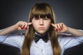 Closeup portrait of worried girl covering her ears, observing. Hear nothing. Human emotions, facial expressions Royalty Free Stock Photo