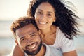 Closeup portrait of an young affectionate mixed race couple standing on the beach and smiling during sunset outdoors Royalty Free Stock Photo