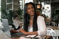 portrait of young african woman relaxing in cafe with laptop an Royalty Free Stock Photo