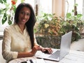 Portrait of young african woman relaxing in cafe with laptop and making phone call, lifestyle and people concept Royalty Free Stock Photo