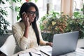 Portrait of young african woman relaxing in cafe with laptop Royalty Free Stock Photo